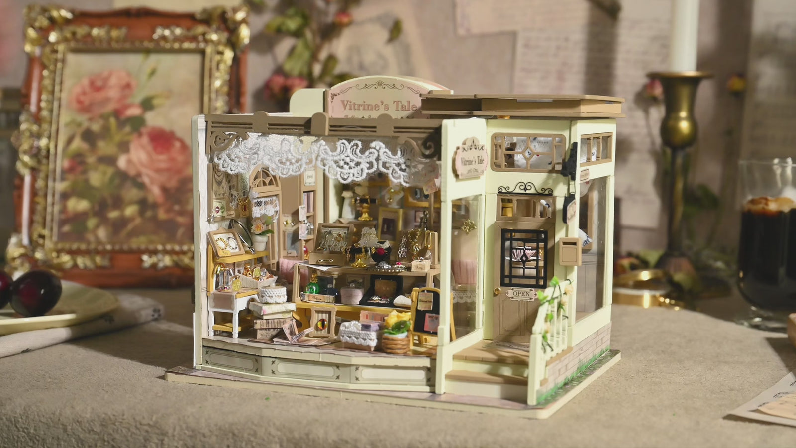 A softly lit miniature studio filled with tiny furniture and warm details
