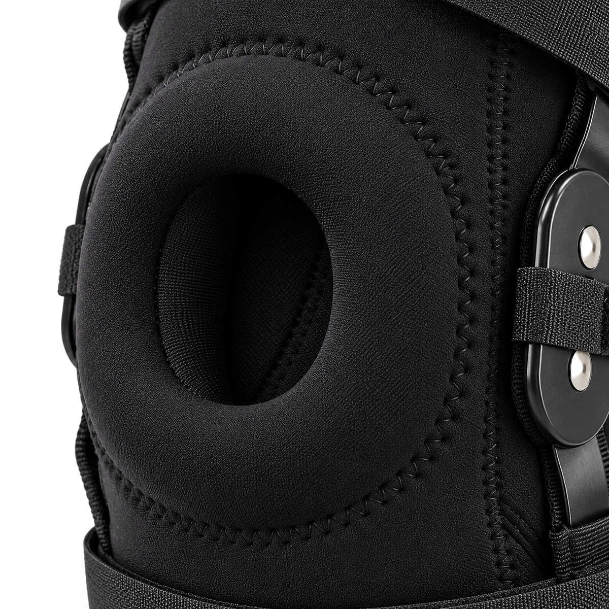 Close-up of the padded oval kneecap opening on the black brace